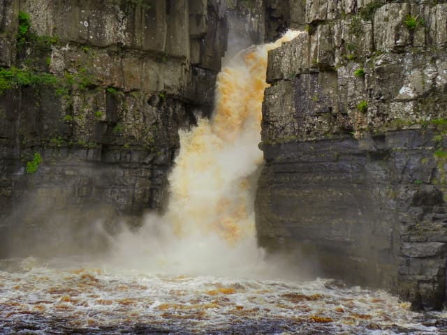 High Force waterfall crashing between rock walls on the River Tees in Teesdale
